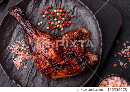 Duck, chicken leg or thigh grilled on a dark concrete background 126536678