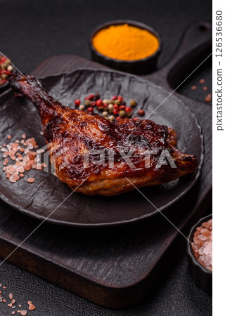 Duck, chicken leg or thigh grilled on a dark concrete background 126536680