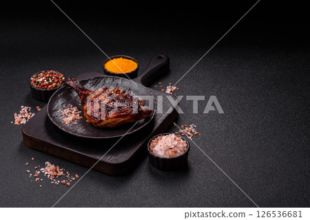 Duck, chicken leg or thigh grilled on a dark concrete background 126536681