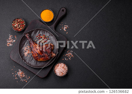Duck, chicken leg or thigh grilled on a dark concrete background Duck, chicken leg or thigh grilled on a dark concrete background 126536682