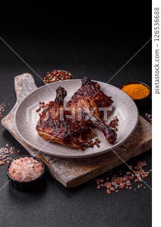Duck, chicken leg or thigh grilled on a dark concrete background 126536688