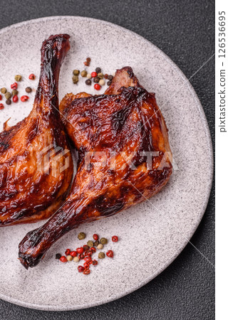Duck, chicken leg or thigh grilled on a dark concrete background 126536695