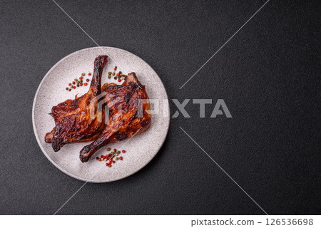 Duck, chicken leg or thigh grilled on a dark concrete background 126536698