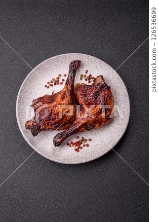 Duck, chicken leg or thigh grilled on a dark concrete background 126536699
