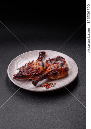 Duck, chicken leg or thigh grilled on a dark concrete background 126536700