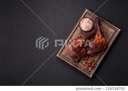 Duck, chicken leg or thigh grilled on a dark concrete background 126536702