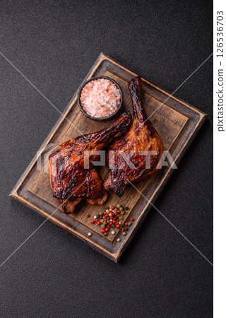 Duck, chicken leg or thigh grilled on a dark concrete background 126536703