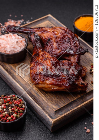 Duck, chicken leg or thigh grilled on a dark concrete background Duck, chicken leg or thigh grilled on a dark concrete background 126536712