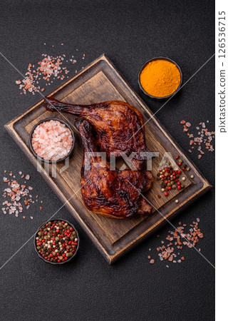 Duck, chicken leg or thigh grilled on a dark concrete background Duck, chicken leg or thigh grilled on a dark concrete background 126536715