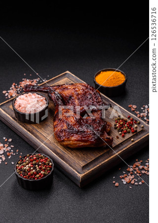 Duck, chicken leg or thigh grilled on a dark concrete background 126536716