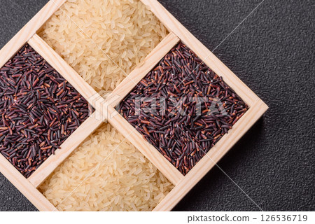 White and red raw rice grains in a ceramic bowl. Rice as an ingredient 126536719