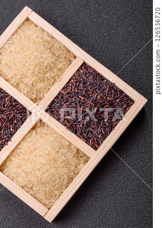 White and red raw rice grains in a ceramic bowl. Rice as an ingredient 126536720