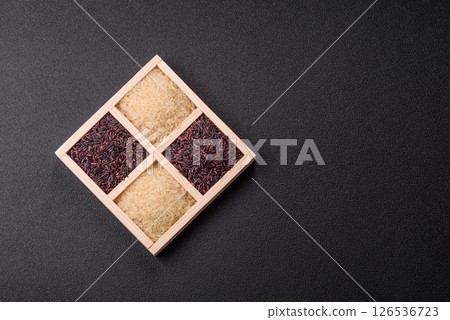 White and red raw rice grains in a ceramic bowl. Rice as an ingredient 126536723