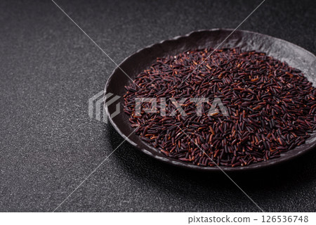 Red or brown raw rice in a ceramic bowl 126536748