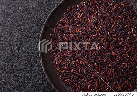 Red or brown raw rice in a ceramic bowl 126536749