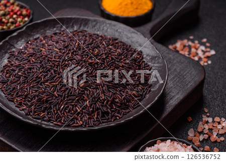 Red or brown raw rice in a ceramic bowl 126536752