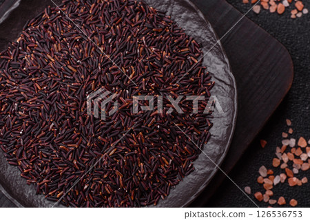Red or brown raw rice in a ceramic bowl 126536753