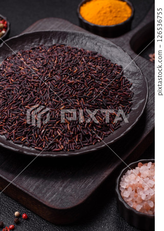 Red or brown raw rice in a ceramic bowl 126536755