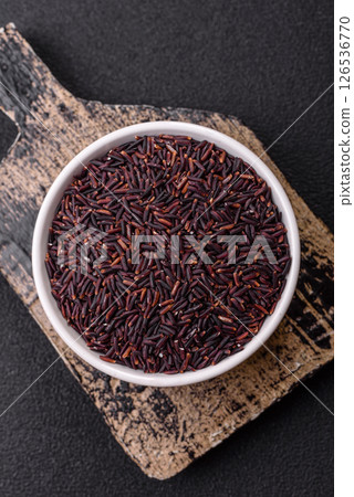 Red or brown raw rice in a ceramic bowl 126536770