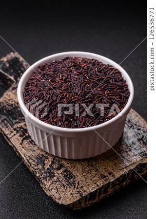 Red or brown raw rice in a ceramic bowl 126536771