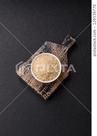 White raw rice in a ceramic bowl. Rice as an ingredient White raw rice in a ceramic bowl. Rice as an ingredient 126536778