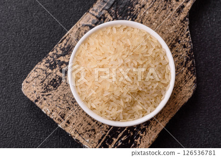 White raw rice in a ceramic bowl. Rice as an ingredient White raw rice in a ceramic bowl. Rice as an ingredient 126536781