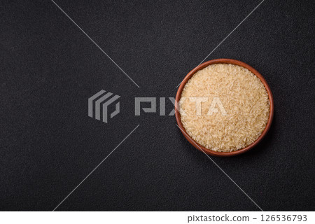 White raw rice in a ceramic bowl. Rice as an ingredient White raw rice in a ceramic bowl. Rice as an ingredient 126536793