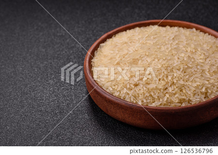 White raw rice in a ceramic bowl. Rice as an ingredient White raw rice in a ceramic bowl. Rice as an ingredient 126536796