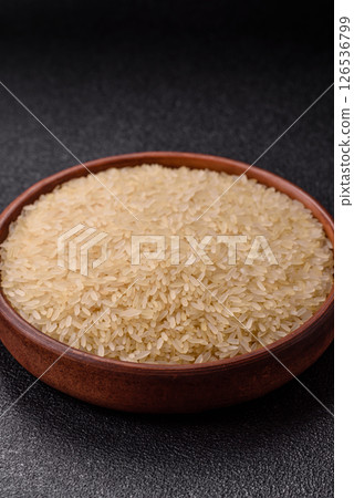 White raw rice in a ceramic bowl. Rice as an ingredient 126536799