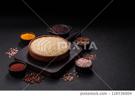 White raw rice in a ceramic bowl. Rice as an ingredient White raw rice in a ceramic bowl. Rice as an ingredient 126536804