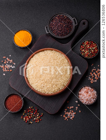White raw rice in a ceramic bowl. Rice as an ingredient White raw rice in a ceramic bowl. Rice as an ingredient 126536806