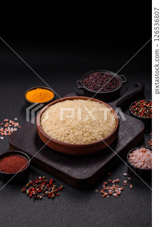 White raw rice in a ceramic bowl. Rice as an ingredient White raw rice in a ceramic bowl. Rice as an ingredient 126536807
