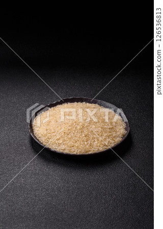 White raw rice in a ceramic bowl. Rice as an ingredient White raw rice in a ceramic bowl. Rice as an ingredient 126536813