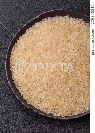 White raw rice in a ceramic bowl. Rice as an ingredient White raw rice in a ceramic bowl. Rice as an ingredient 126536816
