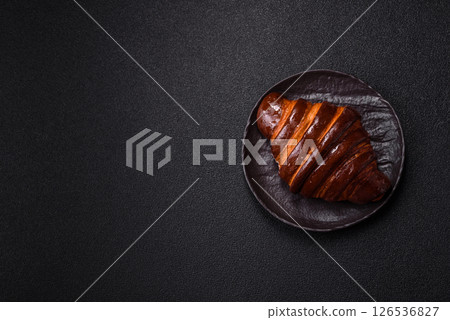 Sweet fresh crispy croissant with chocolate filling Sweet fresh crispy croissant with chocolate filling 126536827
