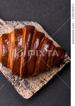 Sweet fresh crispy croissant with chocolate filling 126536851