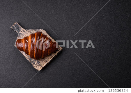 Sweet fresh crispy croissant with chocolate filling 126536854