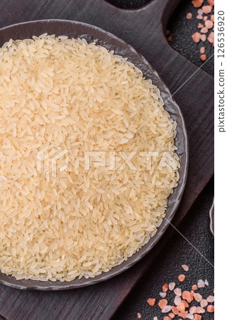 White raw rice in a ceramic bowl. Rice as an ingredient White raw rice in a ceramic bowl. Rice as an ingredient 126536920