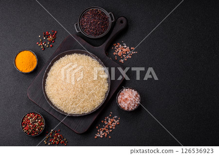 White raw rice in a ceramic bowl. Rice as an ingredient 126536923