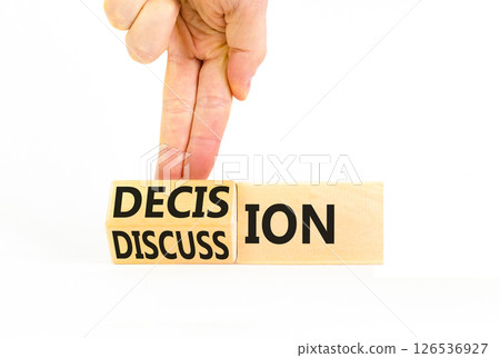 Discussion and decision symbol. Concept word Discussion and Decision on wooden cubes. Businessman hand. Beautiful white table white background. Business discussion and decision concept. Copy space. 126536927