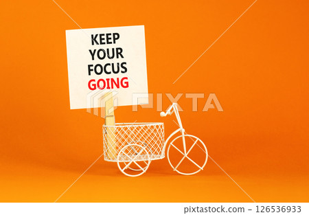 Keep your focus going symbol. Concept words Keep your focus going on beautiful white paper. Beautiful orange background. Miniature bicycle. Business and keep your focus going concept. Copy space. Keep your focus going symbol. Concept words Keep your focus going on beautiful white paper. Beautiful orange background. Miniature bicycle. Business and keep your focus going concept. Copy space. 126536933