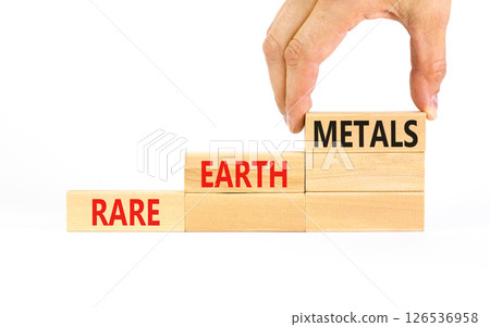 Rare earth metals symbol. Concept words Rare earth metals on beautiful wooden block. Businessman's hand. Beautiful white background. Business and rare earth metals concept. Copy space. 126536958