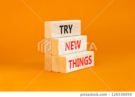 Try new things symbol. Concept words Try new things on beautiful wooden block. Beautiful orange table orange background. Business motivational lifestyle try new things concept. Copy space. 126536959