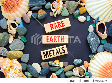 Rare earth metals symbol. Concept words Rare earth metals on beautiful wooden block. Sea stones and shells. Beautiful black background. Business and rare earth metals concept. Copy space. Rare earth metals symbol. Concept words Rare earth metals on beautiful wooden block. Sea stones and shells. Beautiful black background. Business and rare earth metals concept. Copy space. 126536960
