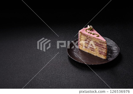A piece of pink layered cake with strawberry flavor 126536976