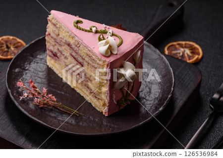 A piece of pink layered cake with strawberry flavor 126536984