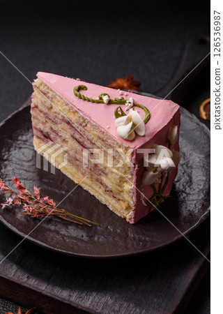 A piece of pink layered cake with strawberry flavor A piece of pink layered cake with strawberry flavor 126536987