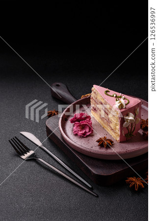 A piece of pink layered cake with strawberry flavor A piece of pink layered cake with strawberry flavor 126536997