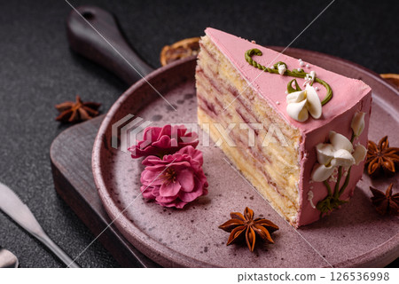A piece of pink layered cake with strawberry flavor 126536998