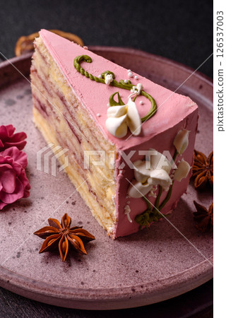 A piece of pink layered cake with strawberry flavor 126537003